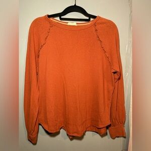 In Loom Women's Orange sweater with ruffle accents and cuffed sleeves, medium